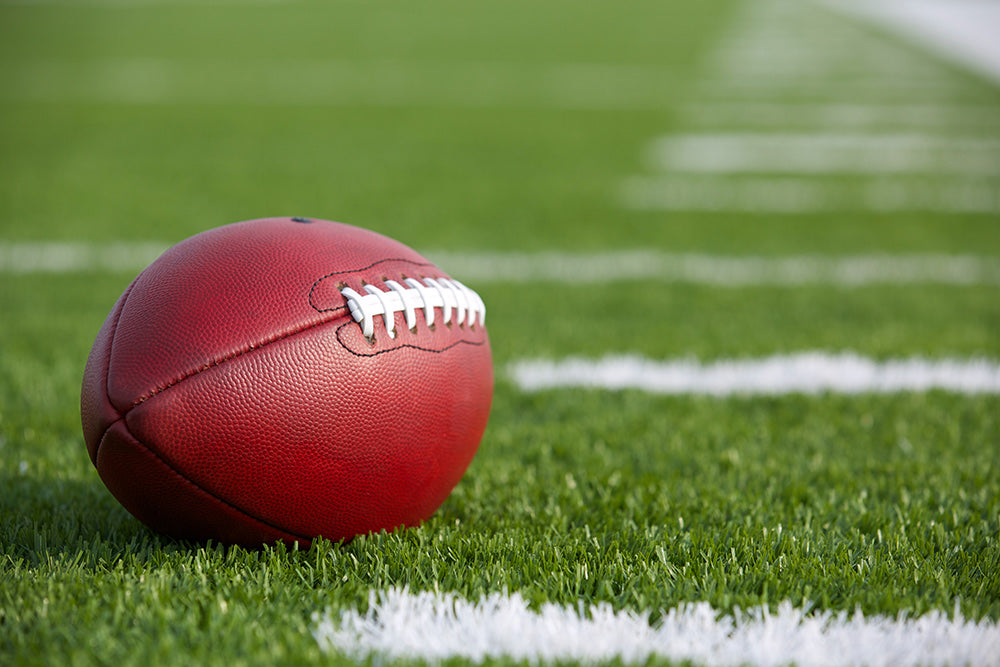 football sporting event ball on grass
